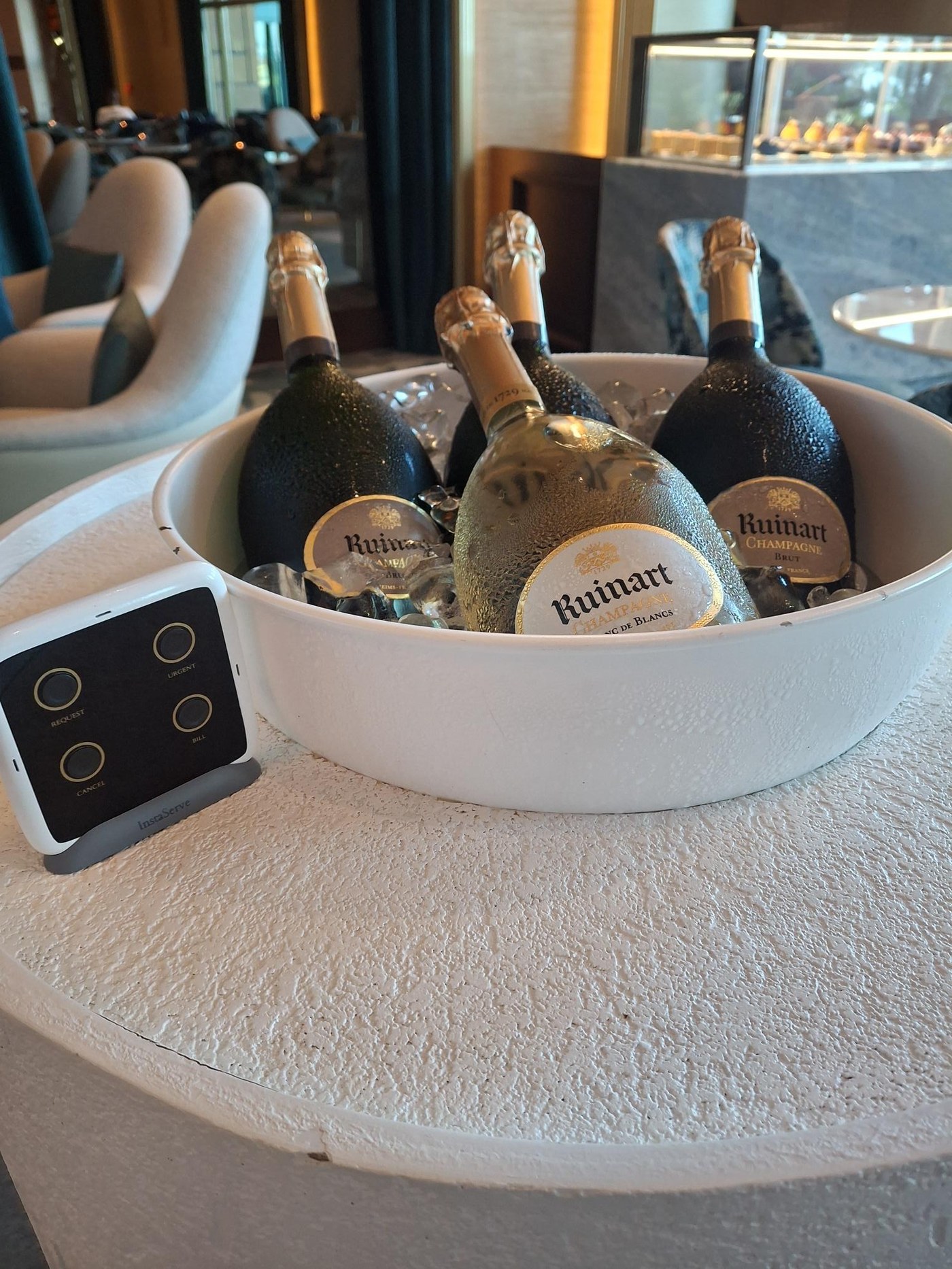 InstaServe console on a guest table beside drinks