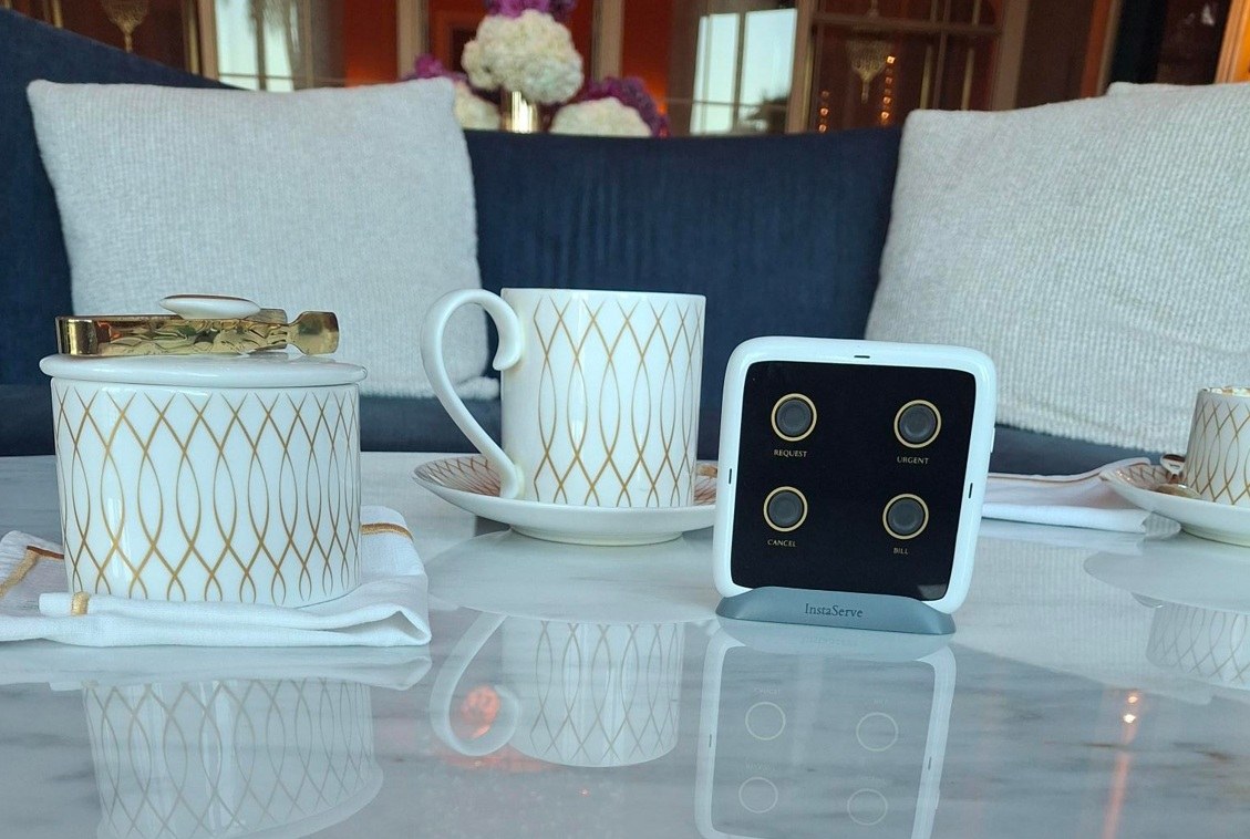 InstaServe table console beside coffee in a café setting