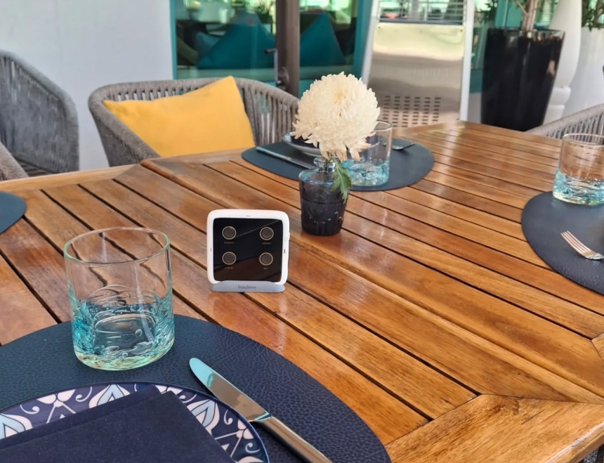 InstaServe console on a wooden hospitality table